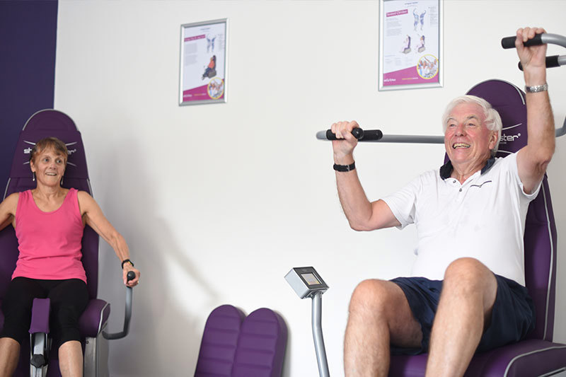 People Using Power Assisted Gym Equipment